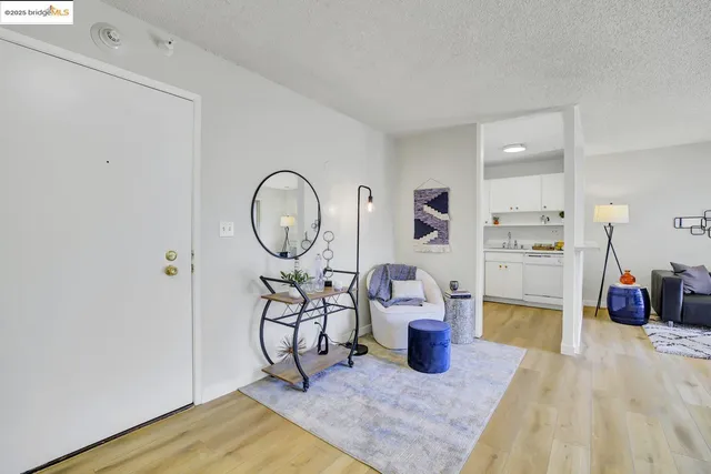 a living room with furniture a flat screen tv and a table