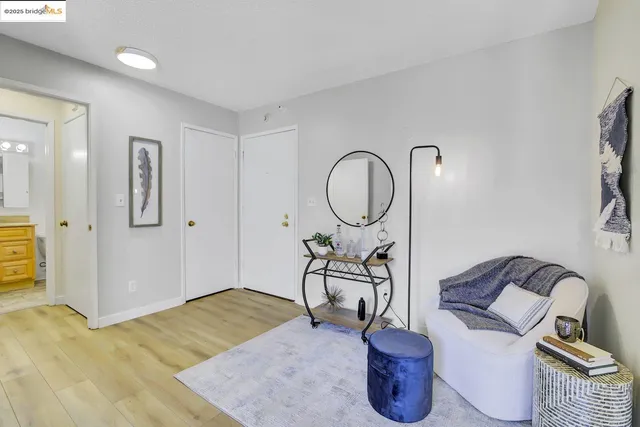 a living room with furniture a flat screen tv and a window