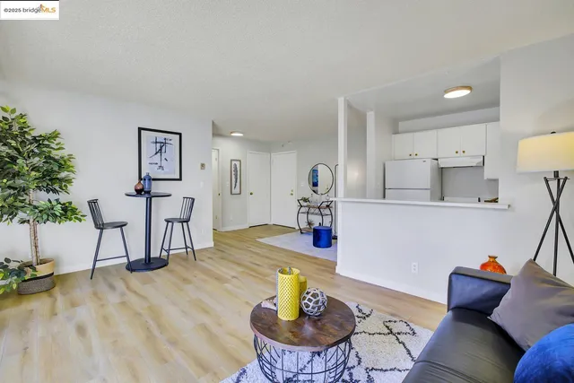 a living room with furniture and a table with wooden floor