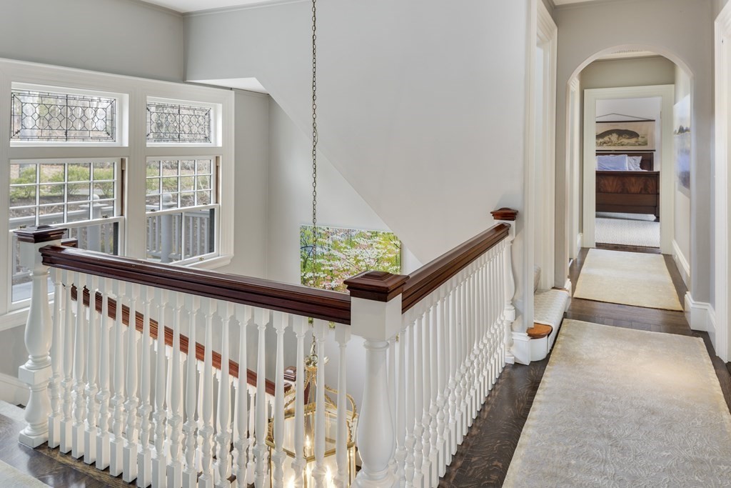 235 Nashawtuc Road Concord, MA 01742 - Photo 12 of 26 a view of staircase with wooden floor and a window