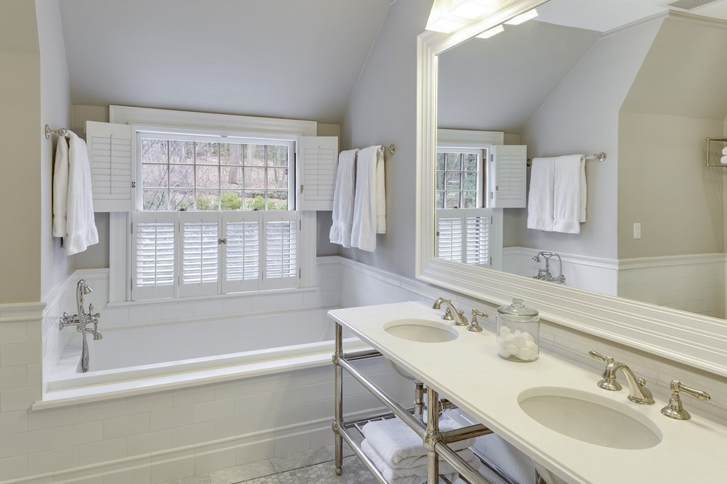 235 Nashawtuc Road Concord, MA 01742 - Photo 16 of 26 a bathroom with a tub sink and mirror