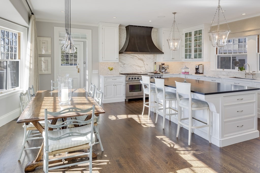 235 Nashawtuc Road Concord, MA 01742 - Photo 8 of 26 a kitchen with stainless steel appliances kitchen island granite countertop a stove a sink a dining table and chairs