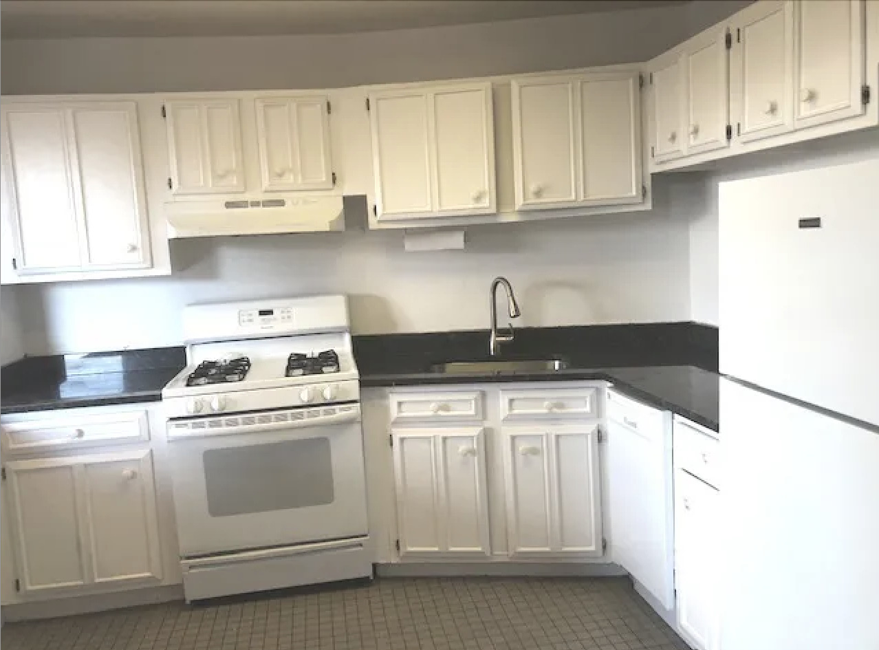 1764 North Clark Street, Unit 3 Chicago, IL 60614 - Photo 2 of 7 a kitchen with white cabinets and white appliances