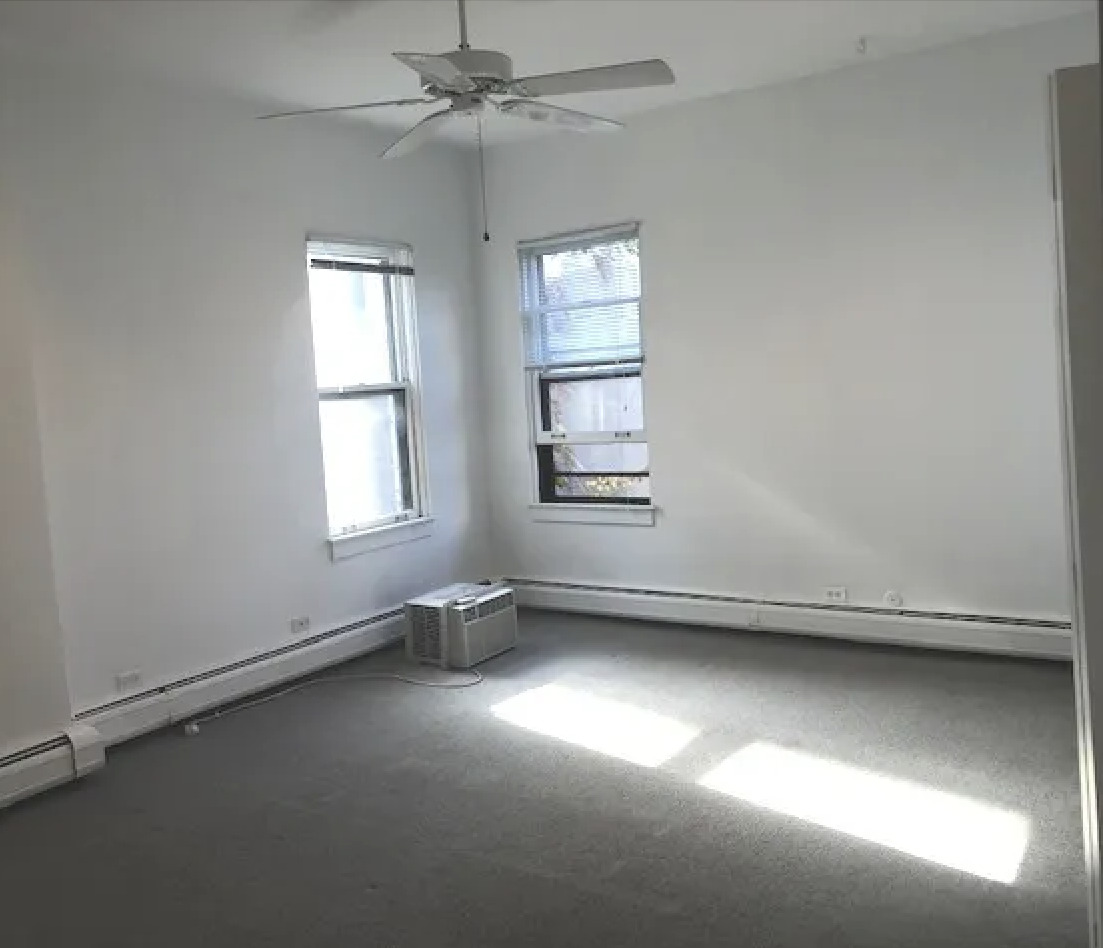 1764 North Clark Street, Unit 3 Chicago, IL 60614 - Photo 5 of 7 an empty room with a window and a ceiling fan