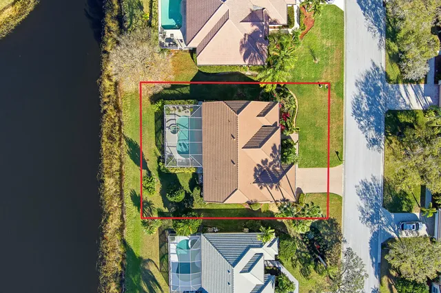 an aerial view of a house with a yard and potted plants