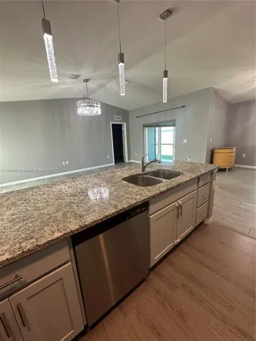 a kitchen with granite countertop a sink and center island