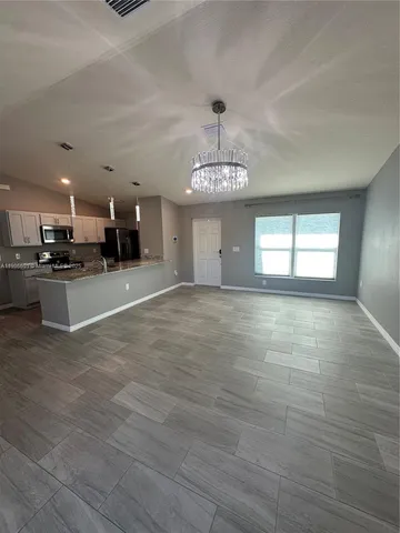 a view of a kitchen with a sink stainless steel appliances and cabinets