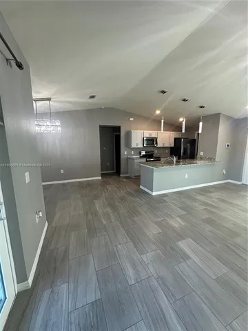 a view of a large kitchen with a wooden floor