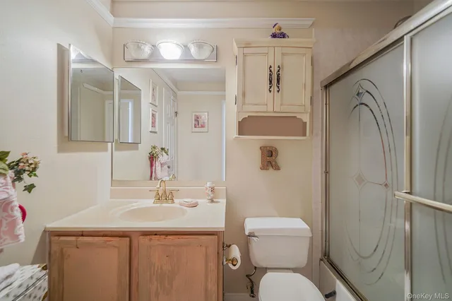 a bathroom with a toilet sink shower and mirror