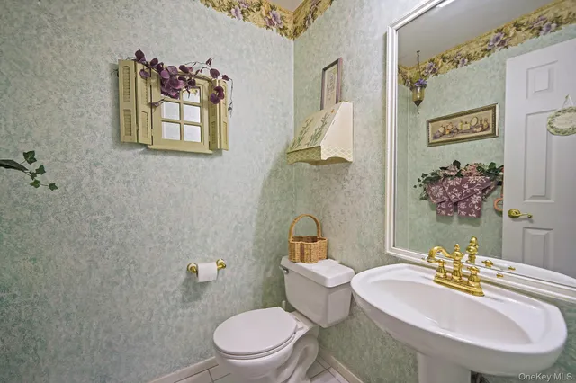 a white toilet sitting next to a bathroom sink