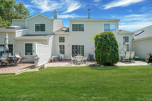 a front view of a house with garden and sitting area