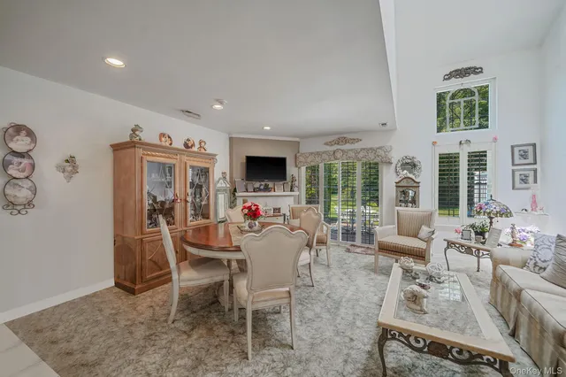 a living room with furniture fireplace and window