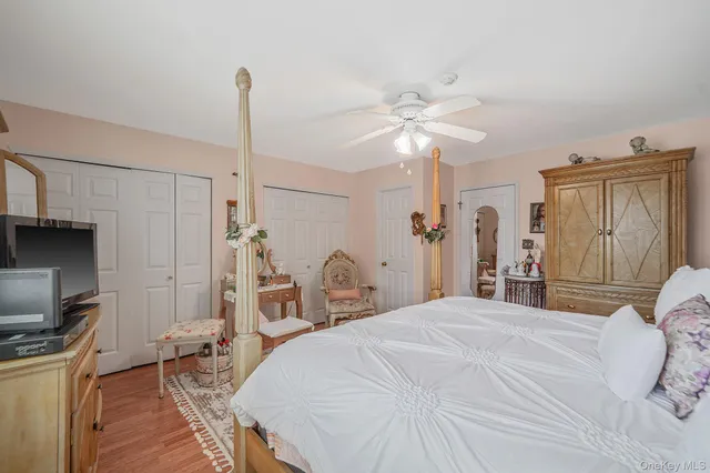 a bedroom with a bed dresser and a chandelier
