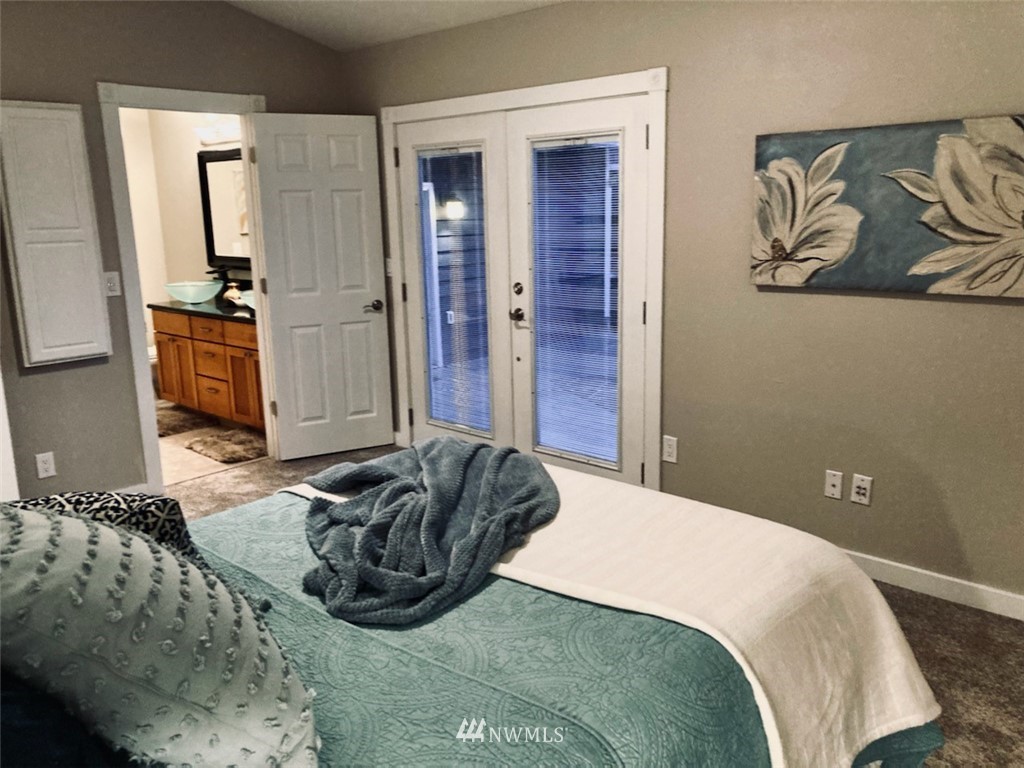 609 213th Street Southwest Bothell, WA 98021 - Photo 11 of 31 a bedroom with a bed and cabinets