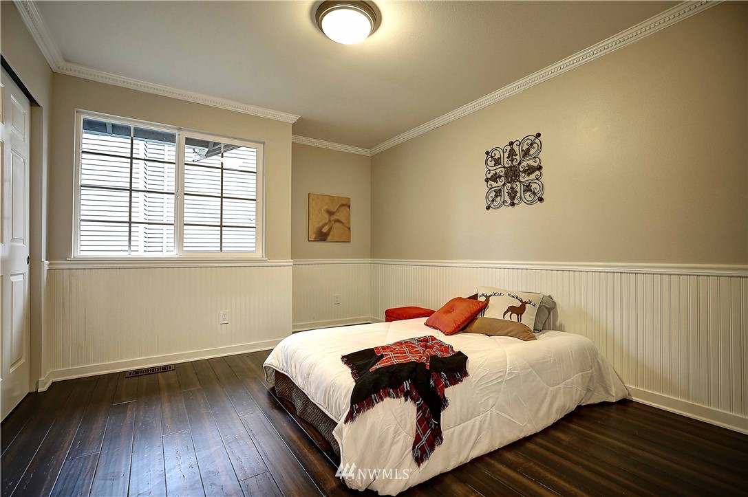 609 213th Street Southwest Bothell, WA 98021 - Photo 15 of 31 a bedroom with a bed and wooden floor