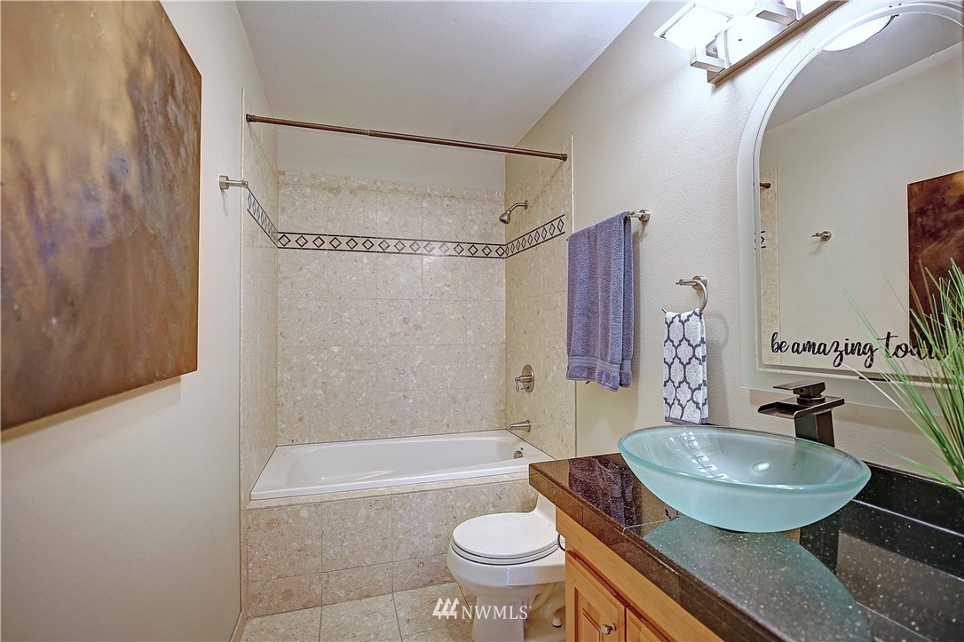 609 213th Street Southwest Bothell, WA 98021 - Photo 16 of 31 a bathroom with a sink toilet and shower