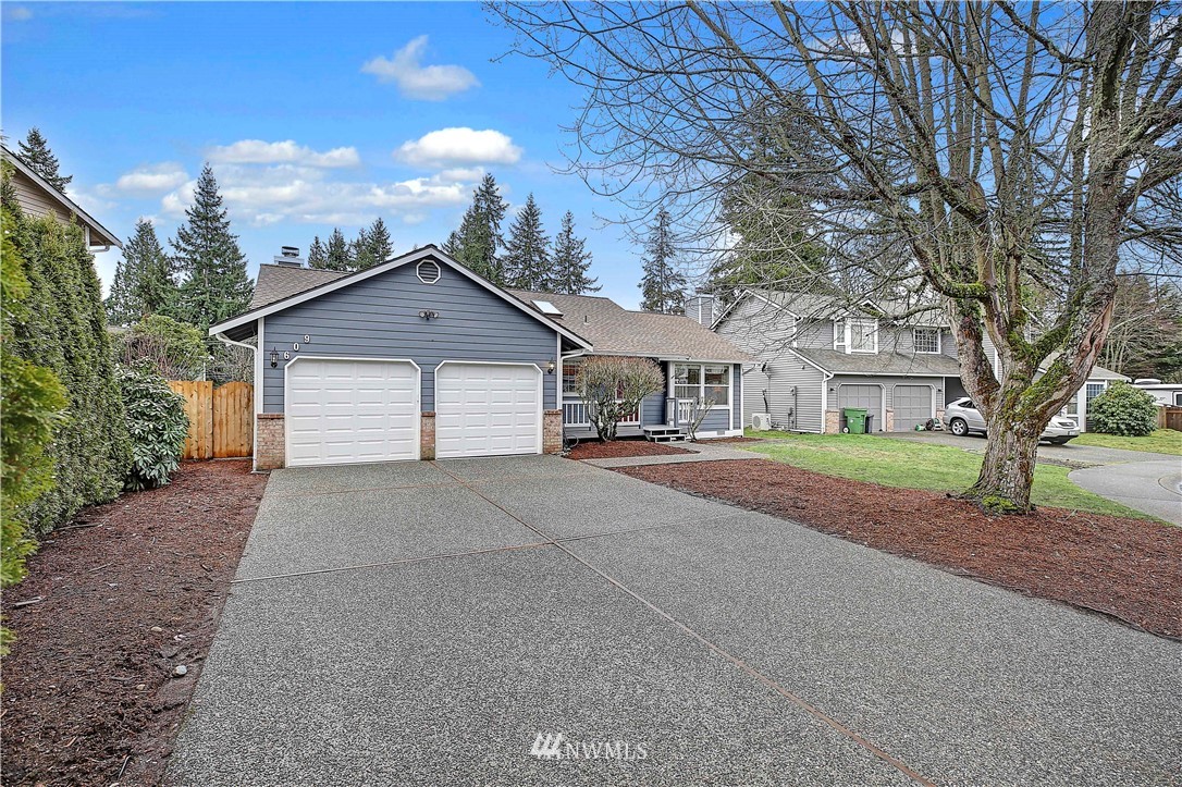 609 213th Street Southwest Bothell, WA 98021 - Photo 2 of 31 a front view of a house with a garden and trees