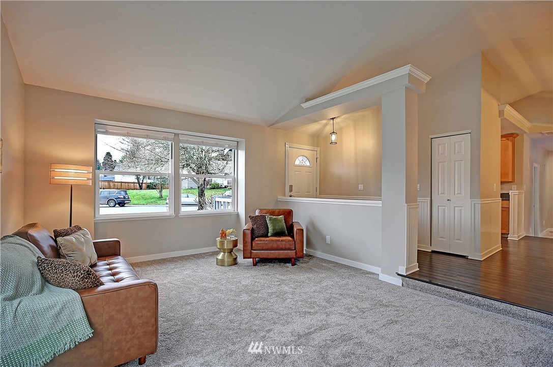 609 213th Street Southwest Bothell, WA 98021 - Photo 4 of 31 a living room with furniture and a large window