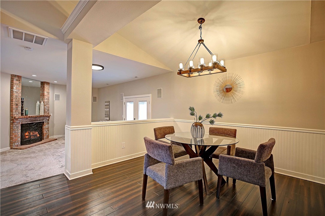 609 213th Street Southwest Bothell, WA 98021 - Photo 5 of 31 a view of a dining room with furniture wooden floor and a chandelier