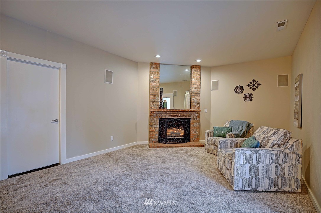 609 213th Street Southwest Bothell, WA 98021 - Photo 6 of 31 a living room with furniture and a fireplace