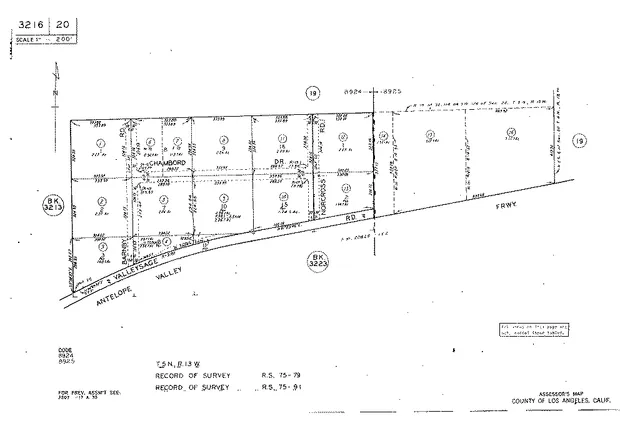 a view of a dry yard with mountains in the background