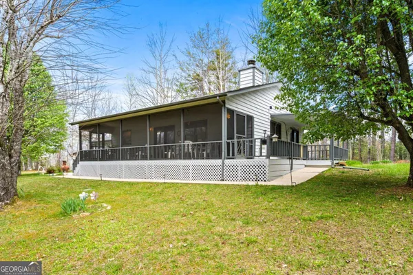 a view of a house with a yard patio and swimming pool