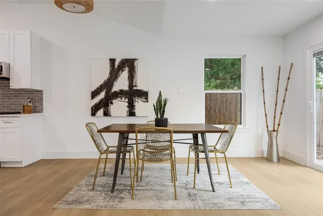 a view of a dining room with furniture and wooden floor