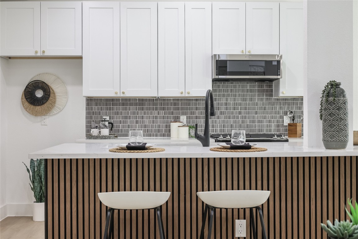 12208 Double Tree Lane Austin, TX 78750 - Photo 14 of 35 a kitchen with a sink a cabinets and a stove