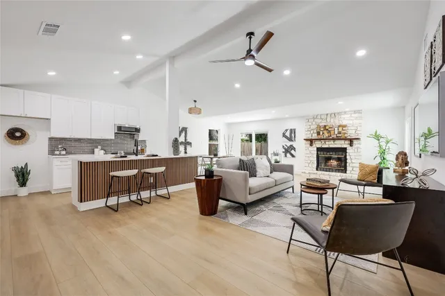 a living room with fireplace furniture and a wooden floor