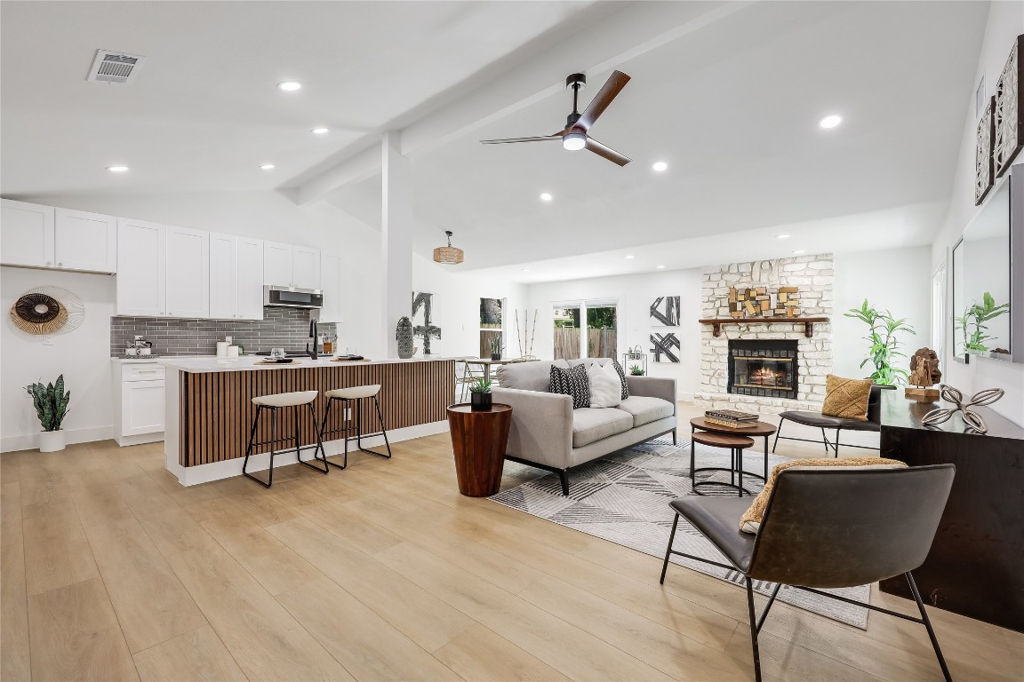 12208 Double Tree Lane Austin, TX 78750 - Photo 15 of 35 a living room with fireplace furniture and a wooden floor