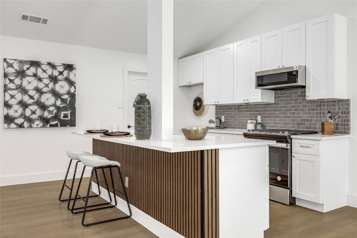 12208 Double Tree Lane Austin, TX 78750 - Photo 16 of 35 a kitchen with stainless steel appliances a sink and a stove