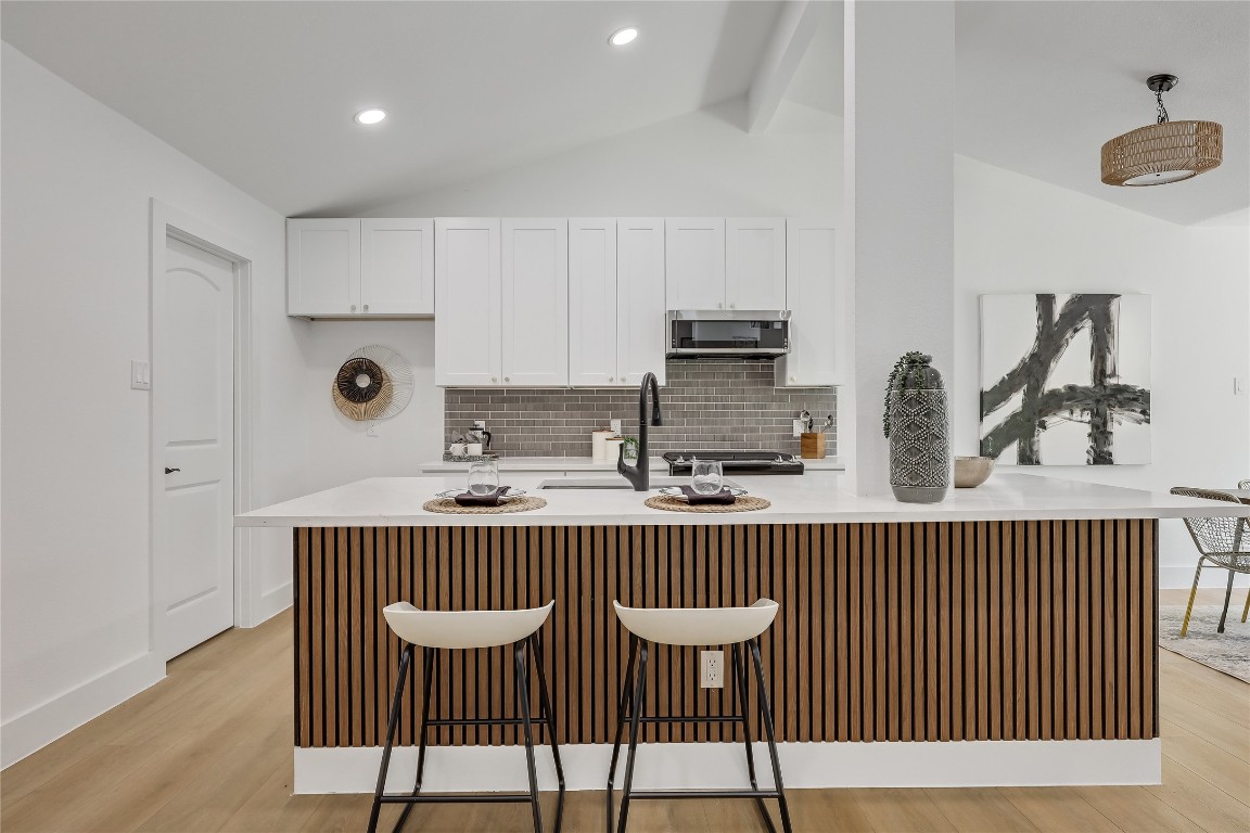 12208 Double Tree Lane Austin, TX 78750 - Photo 19 of 35 a kitchen with a table chairs and a window