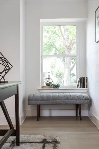 a living room with a window and a table