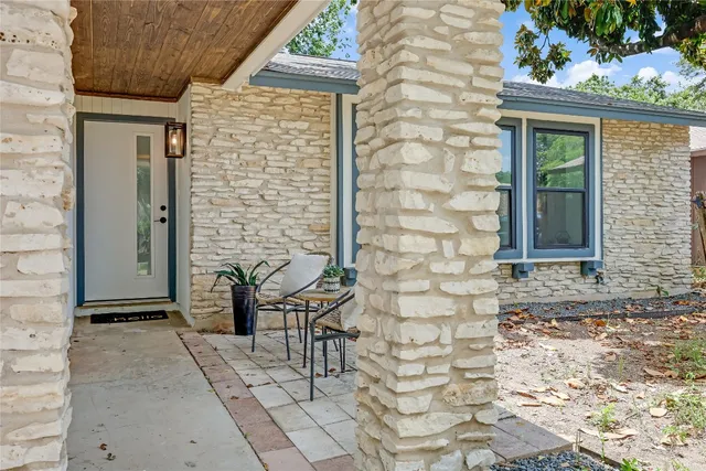 a front view of a house with outdoor seating