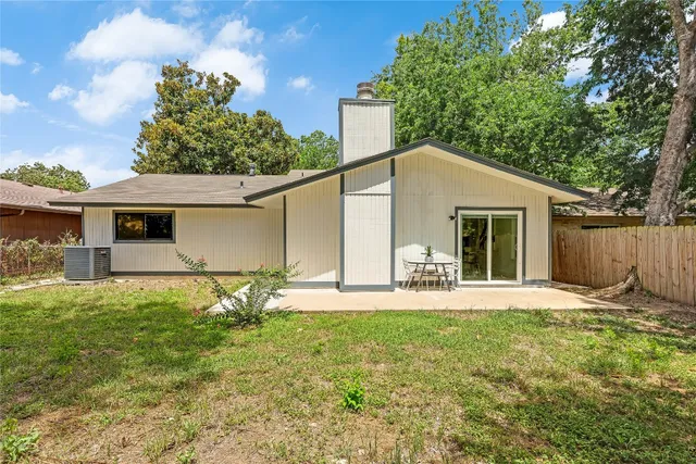 a white house that has tree in front of it