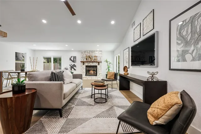 a living room with furniture wooden floor and a flat screen tv