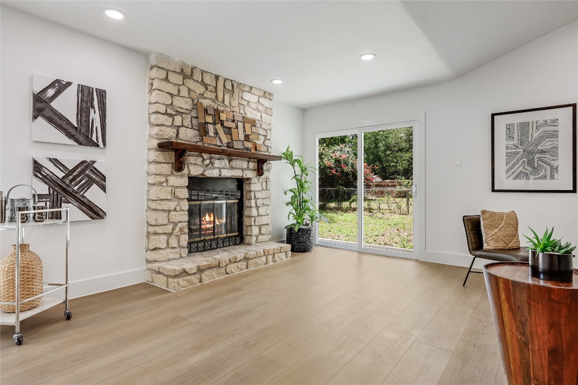 12208 Double Tree Lane Austin, TX 78750 - Photo 8 of 35 a view of an empty room with wooden floor and a fireplace