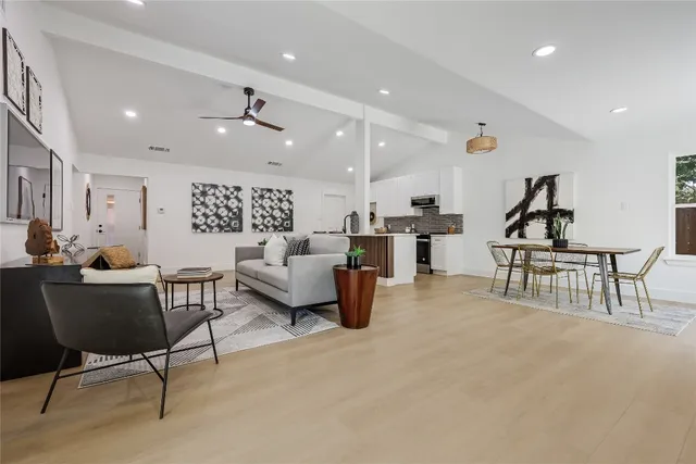 a living room with furniture and a potted plant
