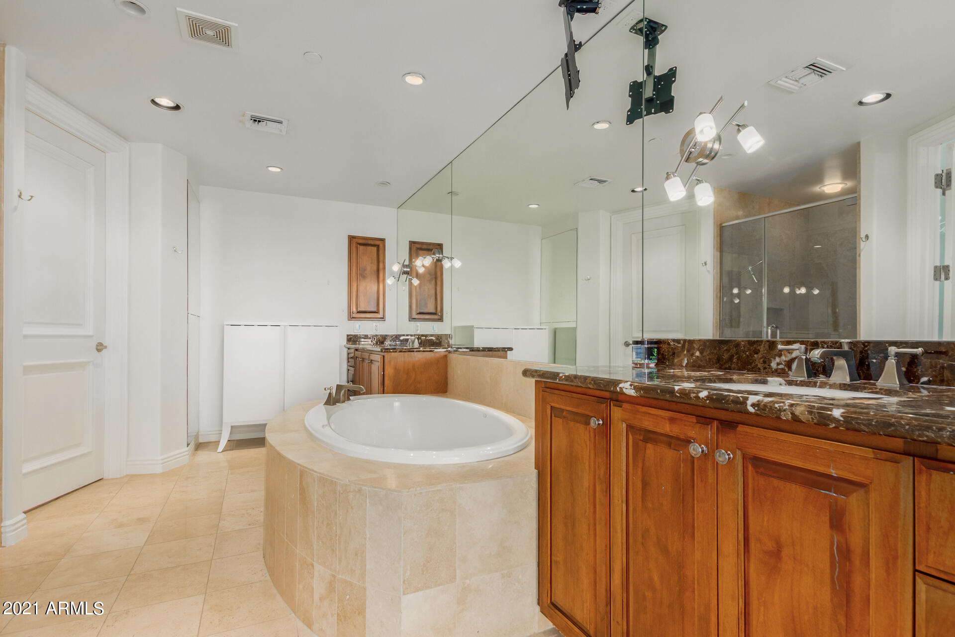 7175 East Camelback Road, Unit 707 Scottsdale, AZ 85251 - Photo 13 of 31 a large bathroom with a sink a large mirror and shower