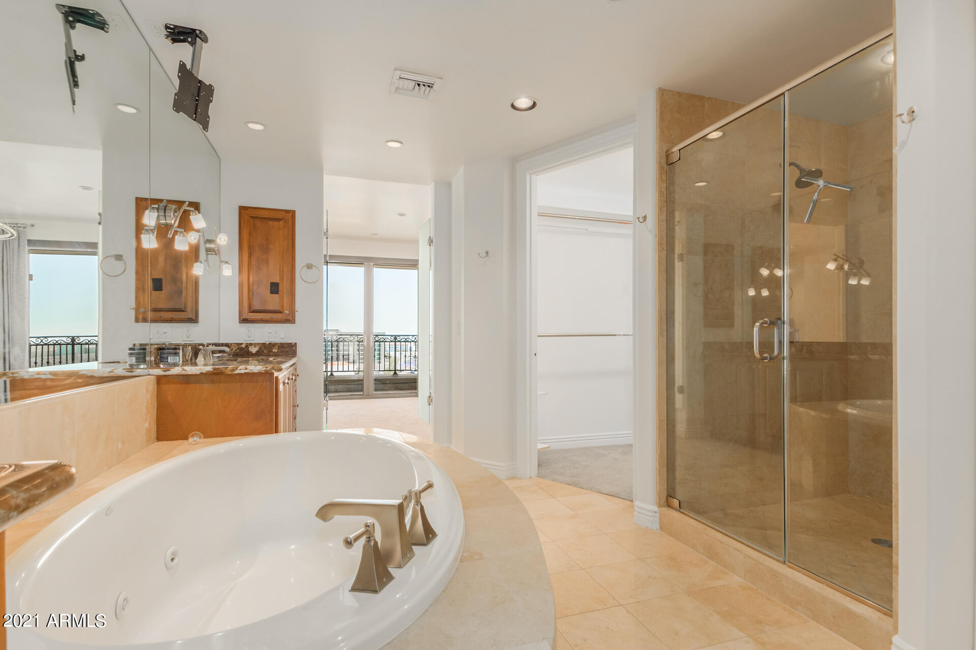 7175 East Camelback Road, Unit 707 Scottsdale, AZ 85251 - Photo 14 of 31 a bathroom with a tub a sink shower and mirror
