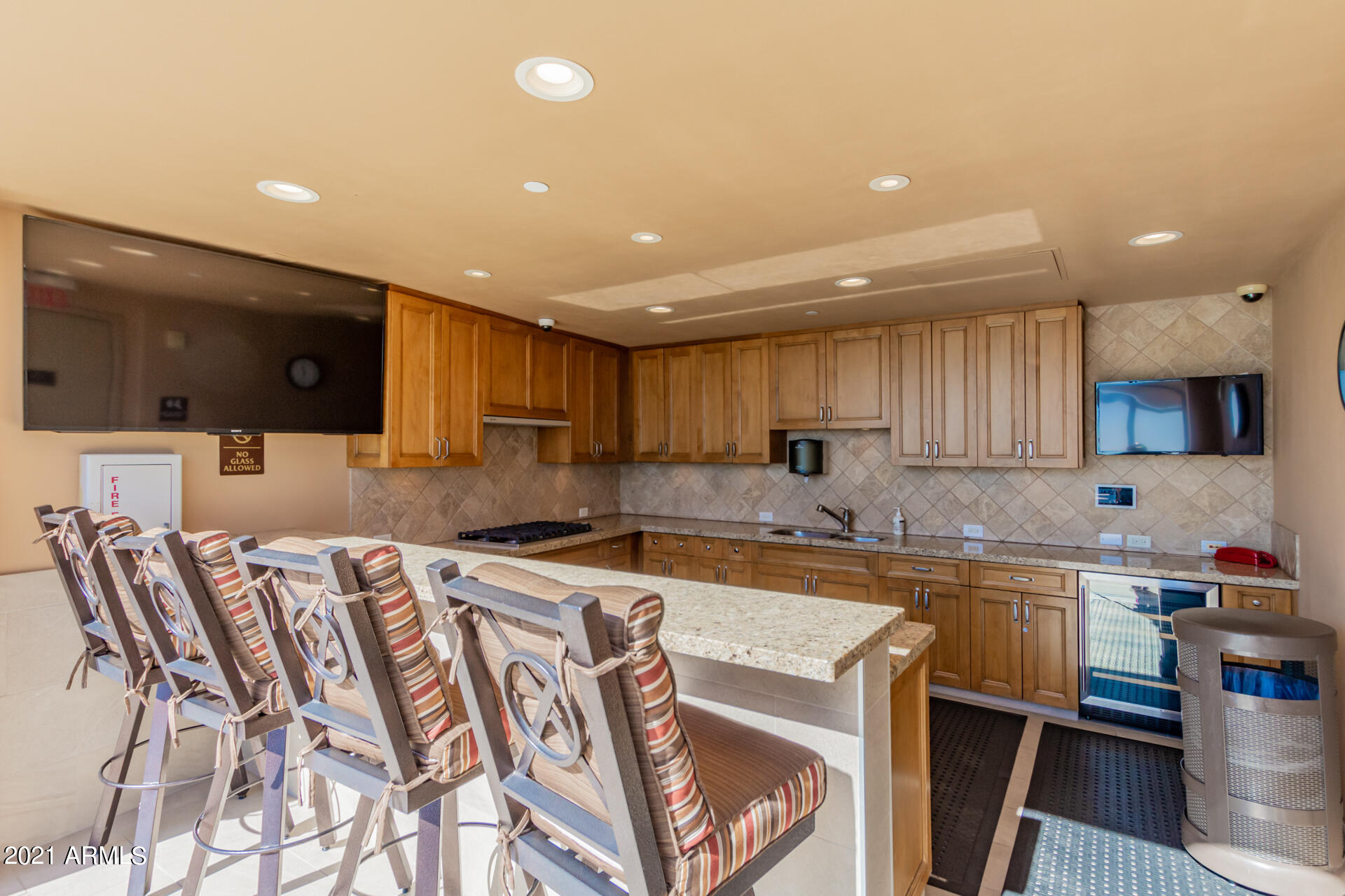 7175 East Camelback Road, Unit 707 Scottsdale, AZ 85251 - Photo 23 of 31 a kitchen with stainless steel appliances granite countertop a sink a stove a microwave a refrigerator and cabinets