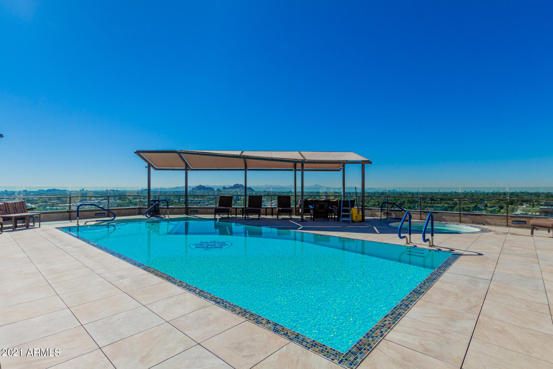 7175 East Camelback Road, Unit 707 Scottsdale, AZ 85251 - Photo 24 of 31 a view of a swimming pool with lounge chairs