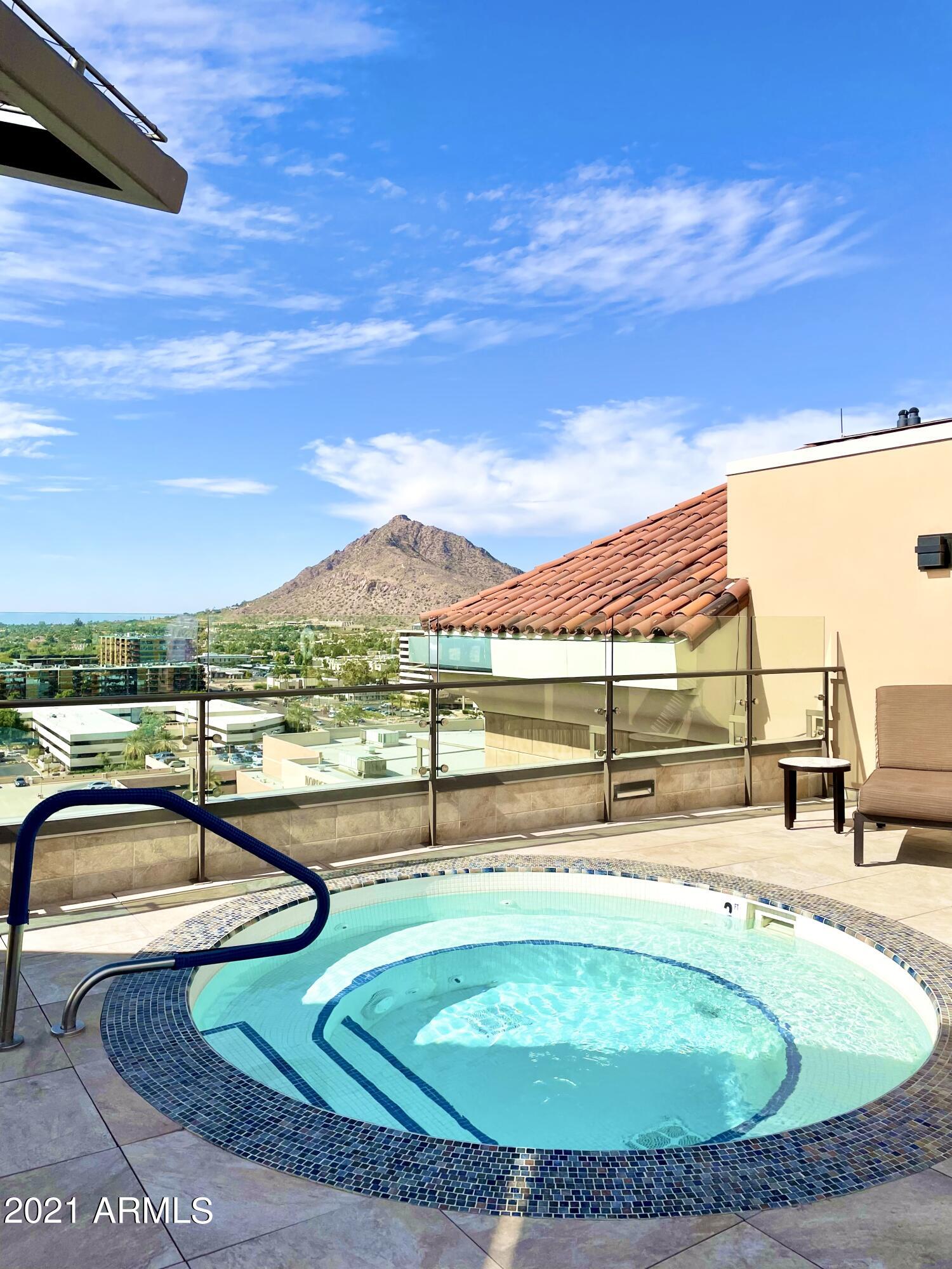 7175 East Camelback Road, Unit 707 Scottsdale, AZ 85251 - Photo 26 of 31 a view of a swimming pool with a patio