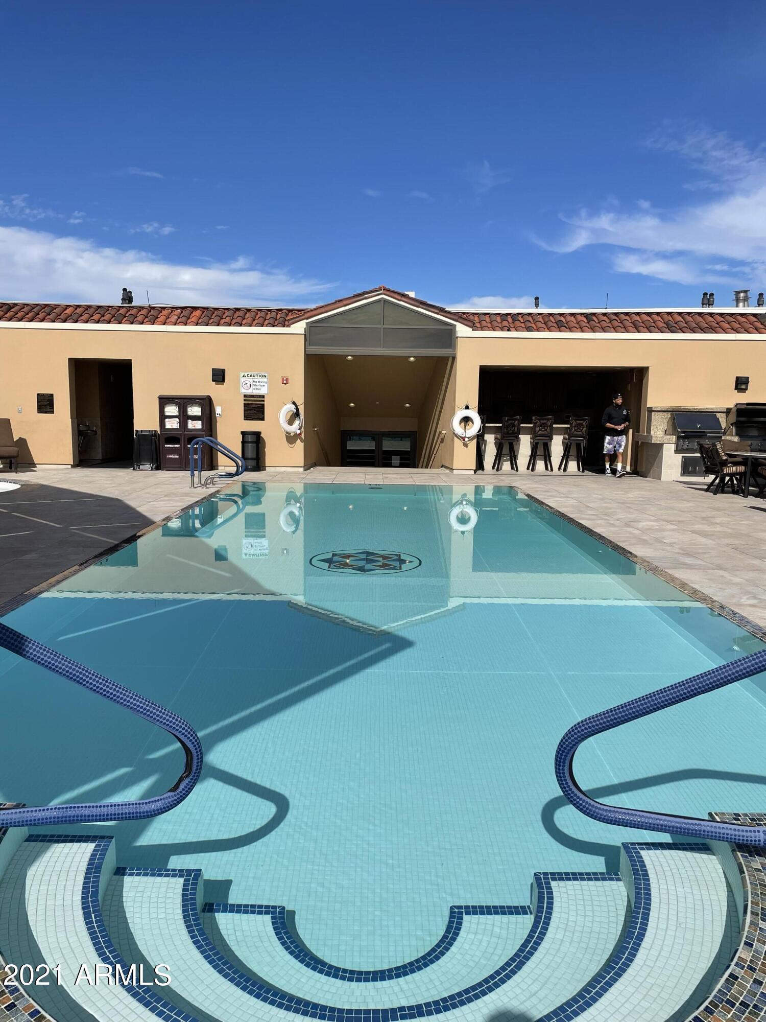 7175 East Camelback Road, Unit 707 Scottsdale, AZ 85251 - Photo 27 of 31 a living room with furniture and a flat screen tv