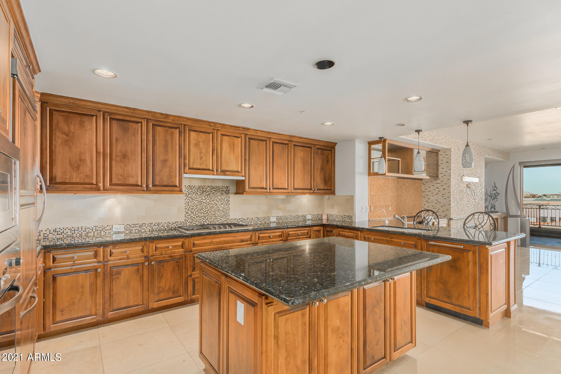 7175 East Camelback Road, Unit 707 Scottsdale, AZ 85251 - Photo 4 of 31 a kitchen filled counter top space a sink a cabinets and appliances