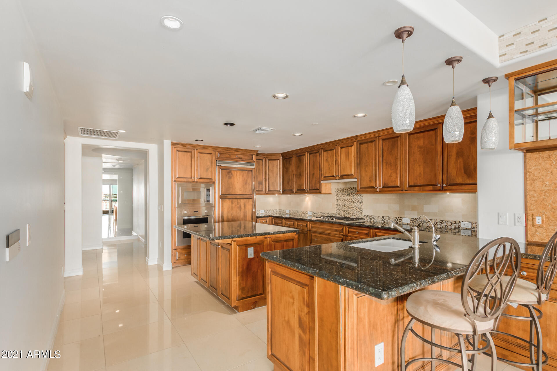 7175 East Camelback Road, Unit 707 Scottsdale, AZ 85251 - Photo 7 of 31 a kitchen with stainless steel appliances granite countertop a sink and a refrigerator