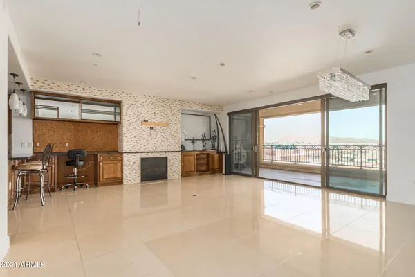 a view of a livingroom with furniture window and a kitchen