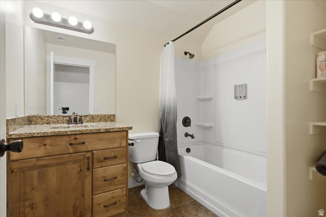 1232 Canyon Road Tooele, UT 84074 - Photo 40 of 54 Bathroom featuring a wood-finish vanity with granite countertop, integrated sink, and bronze-finish faucet
