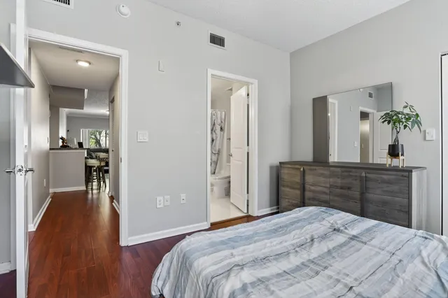 a bedroom with a bed and wooden floor