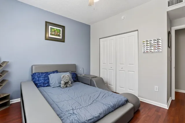a bedroom with a bed and wooden floor